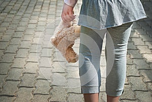 Lonely girl holding a teddy bear as her best friend