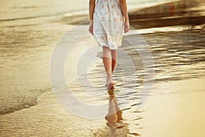 A lonely girl is walking along island coastline