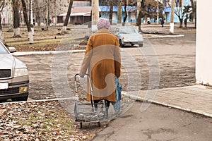 Lonely grandmother Donbass rear view photo