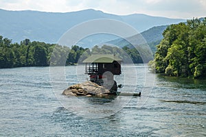 Lonely house on Drina river in Serbia photo