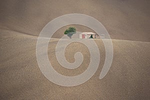 Lonely house on a plowed hill in the countryside