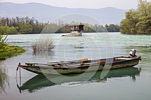 Lonely house and small boat on the river Drina photo
