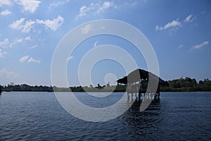 Lonely house on stilts in the river