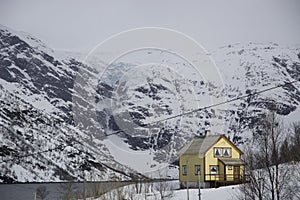 Lonely hut at a Norwegian fjord with avalanche