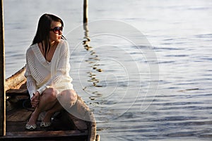 Lonely lady on boat looking sunrise