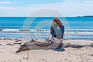 Lonely lady sitting at Atliman beach near Kiten, Bulgaria