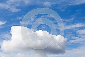 Lonely large cloud in the blue cloudy sky