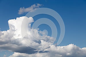 Lonely large cloud in the blue cloudy sky