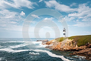 Lonely lighthouse on the coast of Galicia, Spain. Island of Pancha near Ribadeo photo
