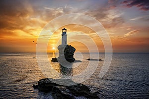 A lonely lighthouse named Tourlitis on a rock in the calm, sea of Greece