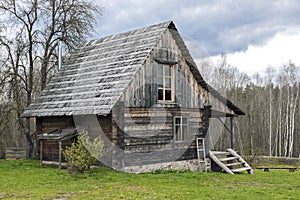 Lonely log cabin surrounded by rural landscape