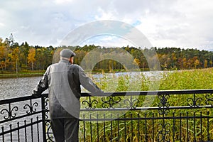 The lonely man costs on the bank of the Quiet lake. Svetlogorsk, Kaliningrad region