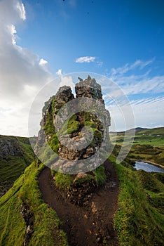 Lonely man, dog, grassland, mountain landscape on top overlook, Fairy Glen, Skye,Scotland, UK.