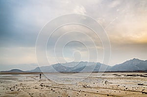 Lonely man far away on beach