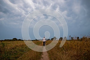 A lonely man goes during a thunderstorm