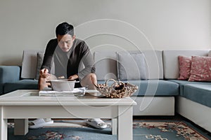 Lonely man having a meal alone in his home.