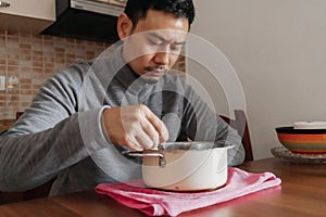 Lonely man having a meal alone in his home.