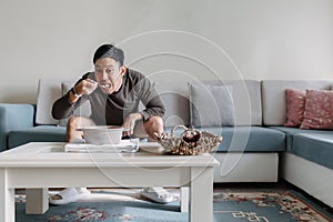 Lonely man having a meal alone in his home.