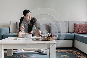 Lonely man having a meal alone in his home.