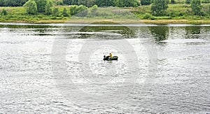 Lonely man in a motor boat on the Volga river photo