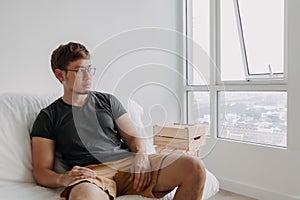 Lonely man sitting lonely in his apartment. Concept of depression.