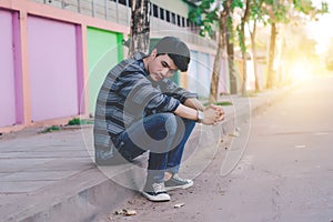 Lonely man sitting on the street