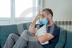 Lonely man suffering from depression at home during coronavirus lockdown and social distancing