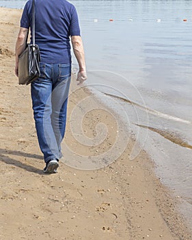 A lonely man walking on the beach. the concept of depression or rest