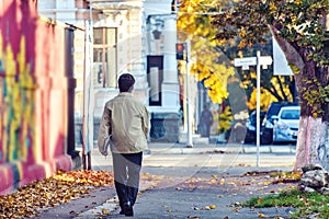 Lonely man walking on Sergey Lazo street with map full of paper photo