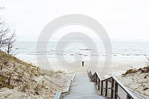 Lonely man walks on the beach along the coastline, mora,