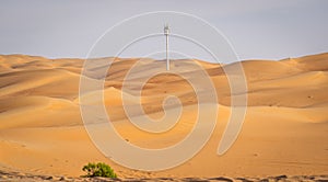A lonely mobile tower in the middle of sand dunes in LIWA desert Abu Dhabi