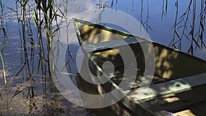 Lonely moored boat floating on a lake or pond.