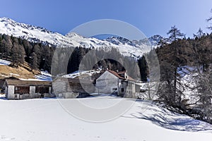 A lonely old farm on the empty and deserted ski slopes during the corona virus lockdown in the Swiss Alps