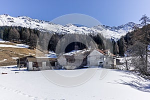 A lonely old farm on the empty and deserted ski slopes during the corona virus lockdown in the Swiss Alps