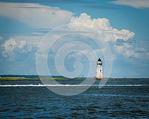 Lonely old lighthouse shot from sea near Tybee Island in Georgia on sunny day