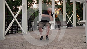 Lonely old man swinging on a swing in the park. One person resting in the park 4k