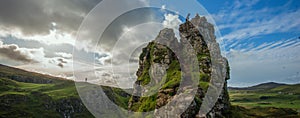 Lonely people, dog, grassland, mountain landscape on top overlook, Fairy Glen, Skye,Scotland, UK.