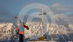 Lonely person portrait and Mountain Birnhorn Saalbach sunset summit cross