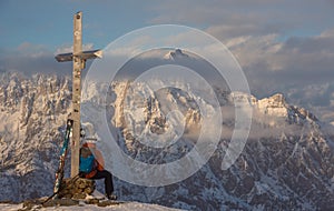 Lonely person portrait and Mountain Birnhorn Saalbach sunset summit cross