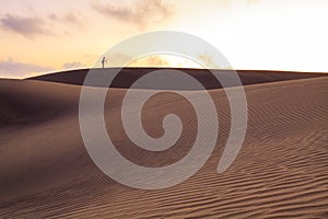 Lonely photographer on dunes in Maspalomas