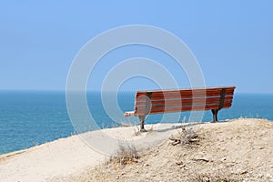 Lonely red painted bench with nice view on the Mediterranean Sea, Ashkelon, Israel. Low key filter