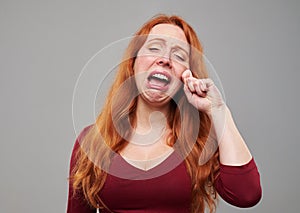 Lonely redhead woman crying