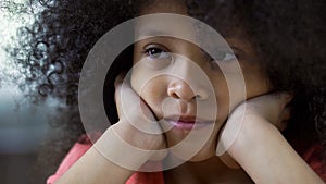 Lonely sad black girl looking straight, thinking about friends, face closeup