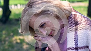 Lonely sad grandmother sitting in nursing home garden, lack of support, memories