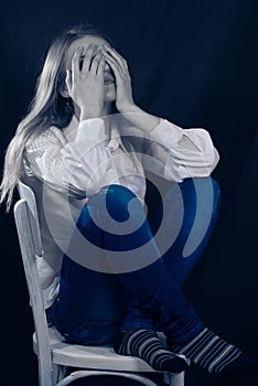 Lonely, Sad or in Pain young woman covering face