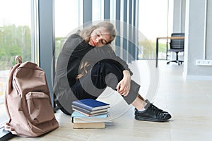 Lonely sad schoolgirl while all her classmates ignored her. Social exclusion problem. Bullying at school concept.