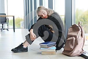 Lonely sad schoolgirl while all her classmates ignored her. Social exclusion problem. Bullying at school concept.