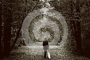 Lonely sad woman on the wood road photo