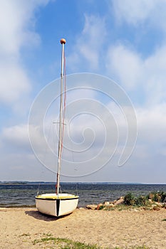 Lonely sailboat on a sandy beach in Rewa