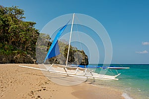 Lonely sailing boat on the sandy beach of Boracay Island Philippines